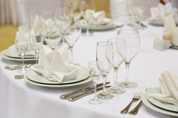 catering table set service with silverware, napkin and glass at restaurant before party
