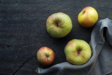 Apples on the dark scratched background top view
