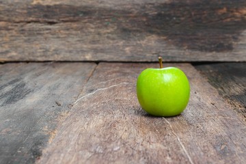 Green apple on wooden table  background, and copy space.