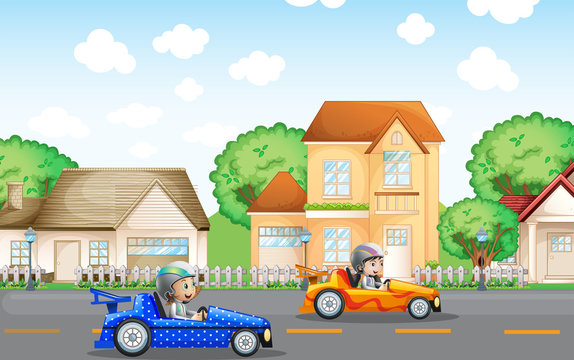 Two kids in racing car driving in neighborhood