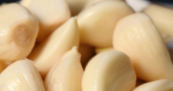 Close up of peeled garlic in rotation