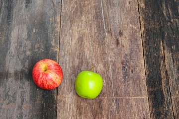 red and green apple on wooden background, top view 
