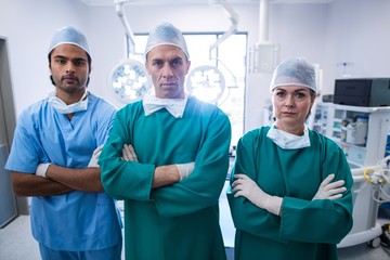 Portrait of surgeons standing with arms crossed
