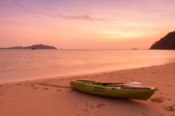 Canoe on the beach at twilight time.