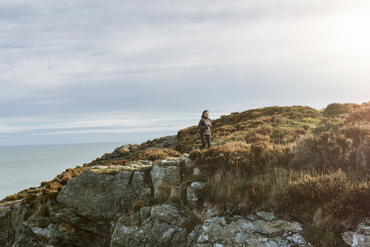 Ireland, Howth, woman running on coastal path