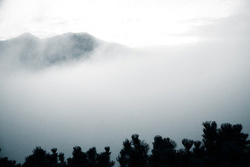 A beautiful monochromatic mountain view with rising clouds
