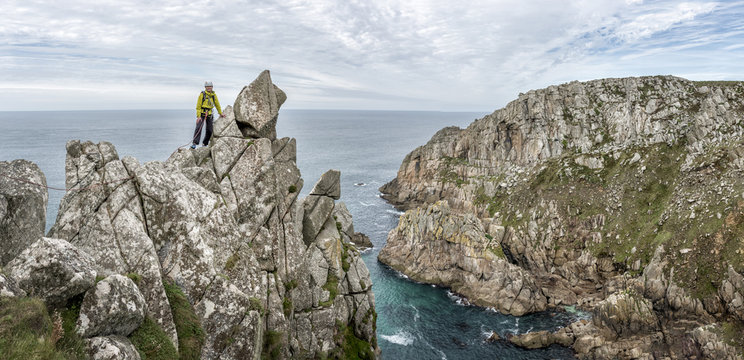 UK, Cornwall, woman on peak of Commando Ridge climbing route