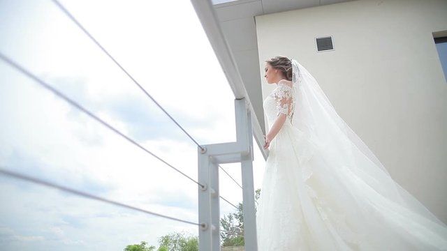 Dream wedding. Beautiful bride waiting for the groom. Bride smiling with happiness. Wedding Celebration. Bright Sunny Day.