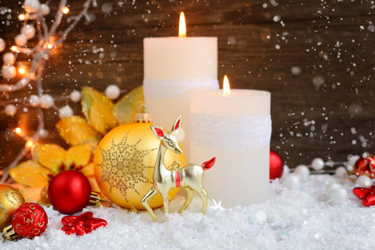 Christmas candles with Christmas ornaments and Christmas lights. Festive Christmas background
