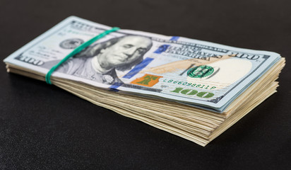 Money roll with US dollars. Selective focus.