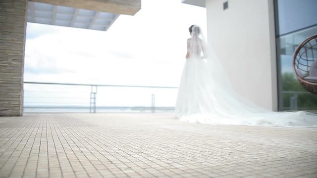 Dream wedding. Beautiful bride waiting for the groom. Bride smiling with happiness. Wedding Celebration. Bright Sunny Day.