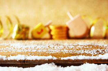 Empty wooden table in front of jewish Hanukkah background