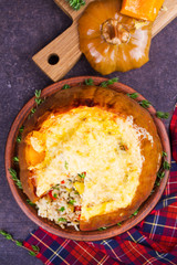 Stuffed pumpkin with meat, rice, mushrooms,  pepper and thyme. Baked butternut squash with rice. View From Above, Top Studio Shot