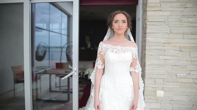 Dream wedding. Beautiful bride waiting for the groom. Bride smiling with happiness. Wedding Celebration. Bright Sunny Day.