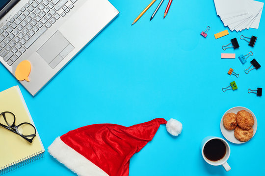 Blue Desk With Laptop, Office Items Coffe And Santa Cup