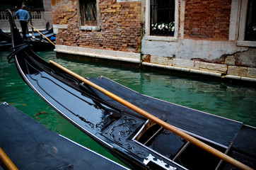 Fototapeta na wymiar Traditional gondola in Venice moored in a canal