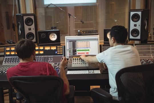 Audio engineers using sound mixer