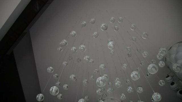 Lights of modern chandelier. Lighting decor. Chandelier close up. Steadicam shot.
