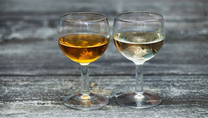 Two different alcohol drinks in wineglasses