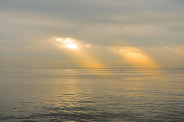 Sun through the clouds at the sea