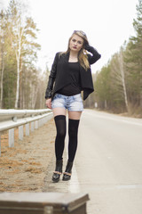 Beautiful young girl hitchhiking