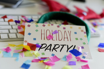 confetti and text holiday party in an office