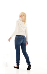 Obraz premium Full length portrait of a pretty girl wearing a casual white hoody and blue jeans. standing pose isolated against a white background.