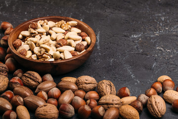 Background of mixed nuts - hazelnuts, walnuts, almonds - with copy space. 