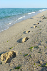 Footprints on Sea beach sand waves