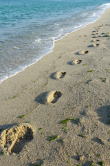 Footprints on Sea beach sand waves