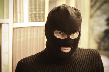 Thief in mask wants to rob the House. He is resolute. Portrait of gangster.