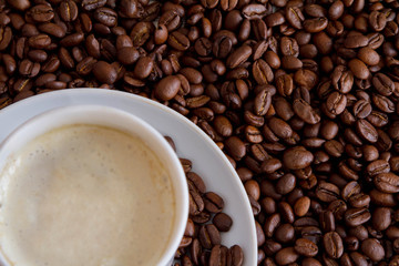 white cup and coffee beans