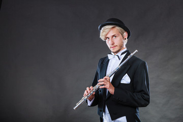 Fototapeta na wymiar Elegantly dressed musician holding flute