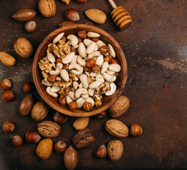 Background of mixed nuts - hazelnuts, walnuts, almonds - with copy space. 