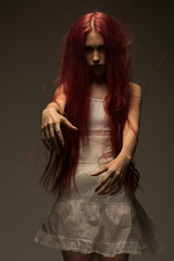 Red haired zombie woman in white cotton dress