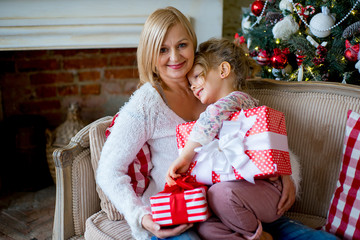 Obraz na płótnie Canvas girl and grandmother with Christmas gifts