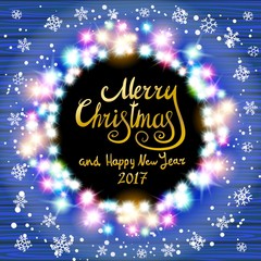 Merry Christmas and Happy New Year 2017. Glowing Christmas wreath made of led lights on the blue wooden background. Christmas lights background.