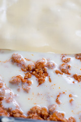 Bechamel sauce with stewed meat and preparing lasagna