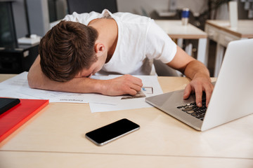 Man sleeping by the table in office