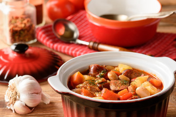 Hot soup with vegetables, smoked sausages and bean.