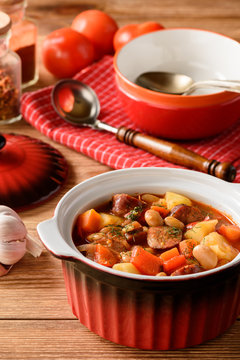 Hot soup with vegetables, smoked sausages and bean.