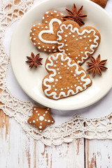 Christmas gingerbread  cookies in the shape of hearts and stars on a white wooden table