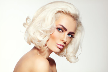 Vintage style portrait of young beautiful tanned sensual platinum blonde girl with stylish make-up and hairdo