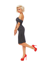 Young beautiful slim sexy platinum blonde woman in vintage polka dot dress over white background