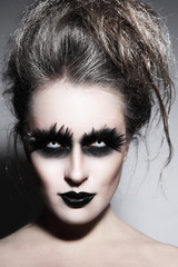 Woman with stylish fancy gothic Halloween make-up and hairdo