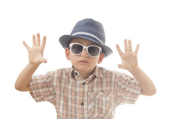 Caucasian kid with hat and sunglasses. Isolated on white background. Space for copy or other design.Showing his hands.