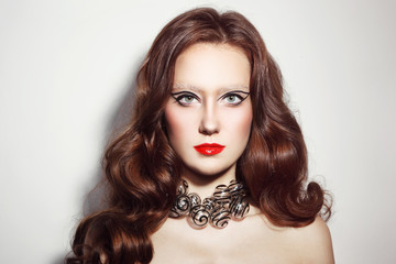 Portrait of young beautiful woman with long curly hair, fancy make-up and stylish glass necklace