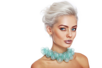 Portrait of young beautiful blonde woman with stylish make-up and hairdo and fancy glass necklace...