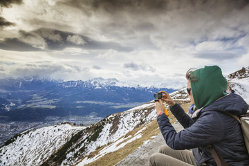 Girl tourist shot on camera views of the Alps from the observati