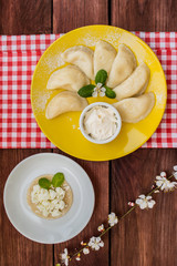 Dumplings with cheese for breakfast. Wooden table. Top view